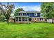 Spacious backyard with blue siding home featuring a sunroom at 1095 Williamsburg Ln, Zionsville, IN 46077