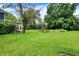 Beautiful, spacious backyard with mature trees and lush green lawn at 1095 Williamsburg Ln, Zionsville, IN 46077