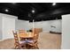 Well-lit basement featuring a dining area, treadmill and a comfortable couch at 1095 Williamsburg Ln, Zionsville, IN 46077