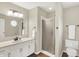 Neutral bathroom featuring a vanity, framed mirror, and glass-enclosed shower at 1095 Williamsburg Ln, Zionsville, IN 46077