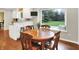 Charming breakfast nook features hardwood floors, and large window with a scenic backyard view at 1095 Williamsburg Ln, Zionsville, IN 46077
