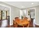 The dining room showcases hardwood floors and an adjacent living room with ample natural light at 1095 Williamsburg Ln, Zionsville, IN 46077