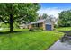 Beautiful home with an attached garage, surrounded by a well-maintained lawn and mature trees at 1095 Williamsburg Ln, Zionsville, IN 46077