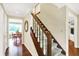 Entryway featuring wood floors, staircase, and views into adjacent rooms filled with natural light at 1095 Williamsburg Ln, Zionsville, IN 46077