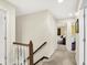 Upstairs hallway with neutral carpet, white trim, and an open view to the bedrooms at 1095 Williamsburg Ln, Zionsville, IN 46077