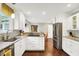 The kitchen showcases stainless appliances, white cabinets, granite counters, and hardwood floors at 1095 Williamsburg Ln, Zionsville, IN 46077