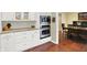 The kitchen offers stainless appliances, updated white cabinetry, and granite countertops at 1095 Williamsburg Ln, Zionsville, IN 46077