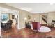 Open-concept living room featuring hardwood floors, a cozy sofa, a dining area, and ample natural light at 1095 Williamsburg Ln, Zionsville, IN 46077