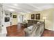 Spacious living room featuring hardwood floors, a comfortable sectional sofa, and built-in shelving at 1095 Williamsburg Ln, Zionsville, IN 46077