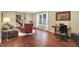 Inviting living room with hardwood floors, a cozy sofa, a decorative chair, and a large window for natural light at 1095 Williamsburg Ln, Zionsville, IN 46077