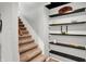 Carpeted stairway featuring painted walls and decorative display shelving at 1095 Williamsburg Ln, Zionsville, IN 46077