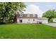 Spacious backyard with lush green grass, mature trees, and a charming garden area perfect for outdoor enjoyment at 1101 High Ct, Carmel, IN 46033