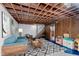 Cozy basement with an open ceiling, playful decor, and a comfortable seating area for relaxation and recreation at 1101 High Ct, Carmel, IN 46033