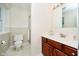 Well-lit bathroom with a white vanity, light wood cabinets, a toilet, and a glass-enclosed shower at 1101 High Ct, Carmel, IN 46033