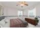 Charming bedroom with a cartoon border, neutral carpet, a ceiling fan, two windows, and a dark wood dresser at 1101 High Ct, Carmel, IN 46033