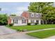 Classic two-story home showcasing a brick and siding exterior, complemented by a lush green lawn at 1101 High Ct, Carmel, IN 46033