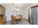 Bright kitchen featuring stainless steel refrigerator, wood floors, wood table with chairs, and ample natural light at 1101 High Ct, Carmel, IN 46033
