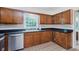 Traditional kitchen with stainless steel appliances, tile floors, wood cabinets, and a window overlooking the backyard at 1101 High Ct, Carmel, IN 46033