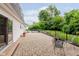 Outdoor patio with brick pavers, wrought iron furniture, and serene views for outdoor dining and relaxation at 1101 High Ct, Carmel, IN 46033