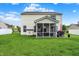 Well-maintained backyard featuring a screened-in porch and patio with outdoor dining set, great for relaxing and entertaining at 1141 Lazio Ct, Greenwood, IN 46143