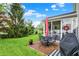 Backyard view with outdoor seating and grill, perfect for entertaining, and a screened in porch for added living space at 1141 Lazio Ct, Greenwood, IN 46143