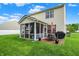 This is the backyard featuring a screened-in porch and patio with an outdoor dining set, ideal for relaxation and dining at 1141 Lazio Ct, Greenwood, IN 46143
