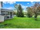 Scenic backyard view with a screened-in porch, offering a serene outdoor space, surrounded by lush greenery and trees at 1141 Lazio Ct, Greenwood, IN 46143