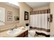 Bathroom with a single vanity, decorative mirror, and shower/tub combo at 1141 Lazio Ct, Greenwood, IN 46143