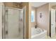 Clean bathroom featuring a shower with glass doors and a separate soaking tub at 1141 Lazio Ct, Greenwood, IN 46143