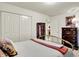 Bright bedroom featuring neutral walls, carpet, and a brass bed frame with a closet at 1141 Lazio Ct, Greenwood, IN 46143