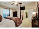 Bright primary bedroom features a ceiling fan, television, and ensuite bathroom access at 1141 Lazio Ct, Greenwood, IN 46143