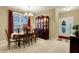 Charming dining room with a hutch and a view of the front entrance with an adorned door at 1141 Lazio Ct, Greenwood, IN 46143