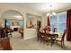 Inviting dining room with a chandelier, dining table with six chairs, and access to the living room at 1141 Lazio Ct, Greenwood, IN 46143