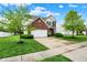Beautiful home exterior featuring a green lawn, mature trees, and a long driveway at 1141 Lazio Ct, Greenwood, IN 46143