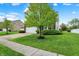 Well-kept front yard with green grass and mature trees enhance this home's curb appeal at 1141 Lazio Ct, Greenwood, IN 46143