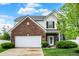 Charming two-story brick home with an attached garage and well-manicured lawn at 1141 Lazio Ct, Greenwood, IN 46143
