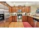 Modern kitchen featuring stainless steel appliances, wooden cabinets, and hardwood floors at 1141 Lazio Ct, Greenwood, IN 46143