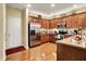 Modern kitchen featuring stainless steel appliances, wooden cabinets, and a hardwood floor at 1141 Lazio Ct, Greenwood, IN 46143