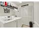 Modern laundry room featuring white appliances, ample storage, and contemporary design at 1141 Lazio Ct, Greenwood, IN 46143