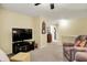 Upstairs living room featuring neutral carpet, a ceiling fan, and bright natural light at 1141 Lazio Ct, Greenwood, IN 46143