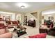 Spacious living room featuring sofas, a piano, and staircase leading to upper level at 1141 Lazio Ct, Greenwood, IN 46143