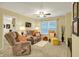 Comfortable living room featuring neutral carpeting, a ceiling fan, and relaxing furniture at 1141 Lazio Ct, Greenwood, IN 46143