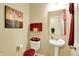 Cozy powder room featuring a white pedestal sink, decorative accents, and a neutral color scheme at 1141 Lazio Ct, Greenwood, IN 46143