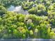 Beautiful aerial view of a home nestled among lush trees near a picturesque lake at 12142 N Paddock Rd, Camby, IN 46113