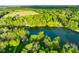 Stunning aerial view of a secluded lake surrounded by lush greenery and trees at 12142 N Paddock Rd, Camby, IN 46113