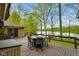 Spacious deck with dining set and beautiful lake views, perfect for outdoor entertaining and relaxation at 12142 N Paddock Rd, Camby, IN 46113
