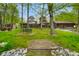 Lush backyard with mature trees, picnic table, and charming home exterior at 12142 N Paddock Rd, Camby, IN 46113
