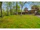 Spacious backyard with lush greenery, wooden swing, patio and home exterior at 12142 N Paddock Rd, Camby, IN 46113
