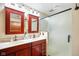 Bright bathroom featuring double vanity with warm lighting and glass shower enclosure at 12142 N Paddock Rd, Camby, IN 46113