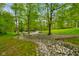Scenic driveway leading up to a charming home surrounded by lush greenery at 12142 N Paddock Rd, Camby, IN 46113